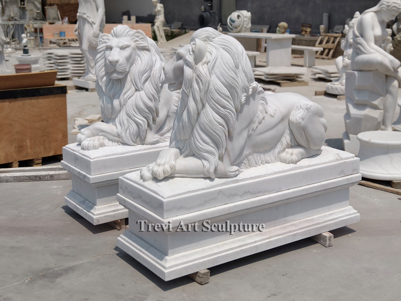 White marble lion statue in front of house