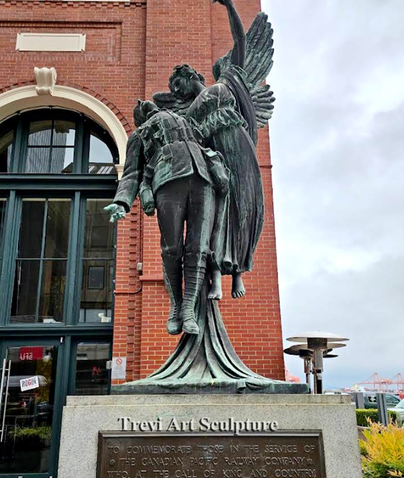 angel of victory holding fallen solider statue