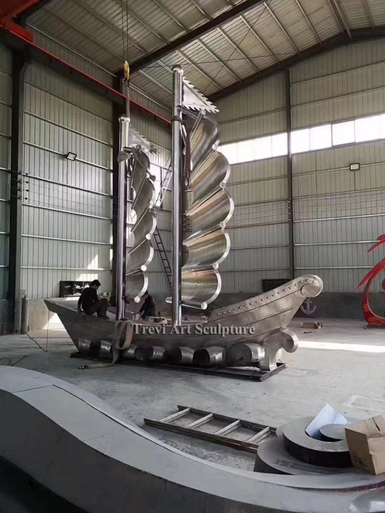 large stainless steel sailboat sculpture