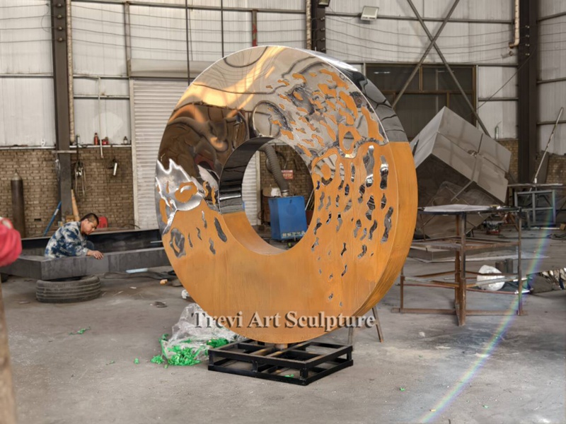 Stainless metal and corten steel circle sculpture