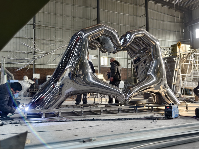 large stainless steel heart shape hand sculpture